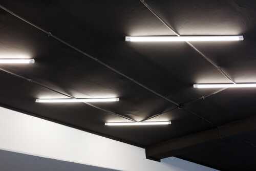Led tube lights on black office ceiling